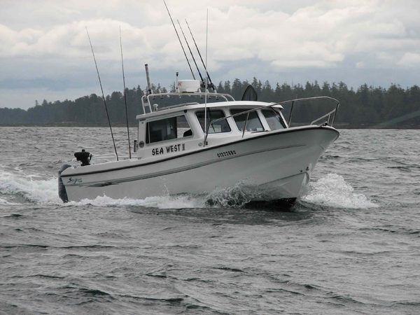 A trim sport-fishing boat running across open water off Haida Gwaii