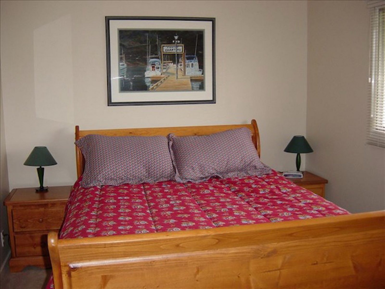 A private guest bedroom with a wooden bed frame