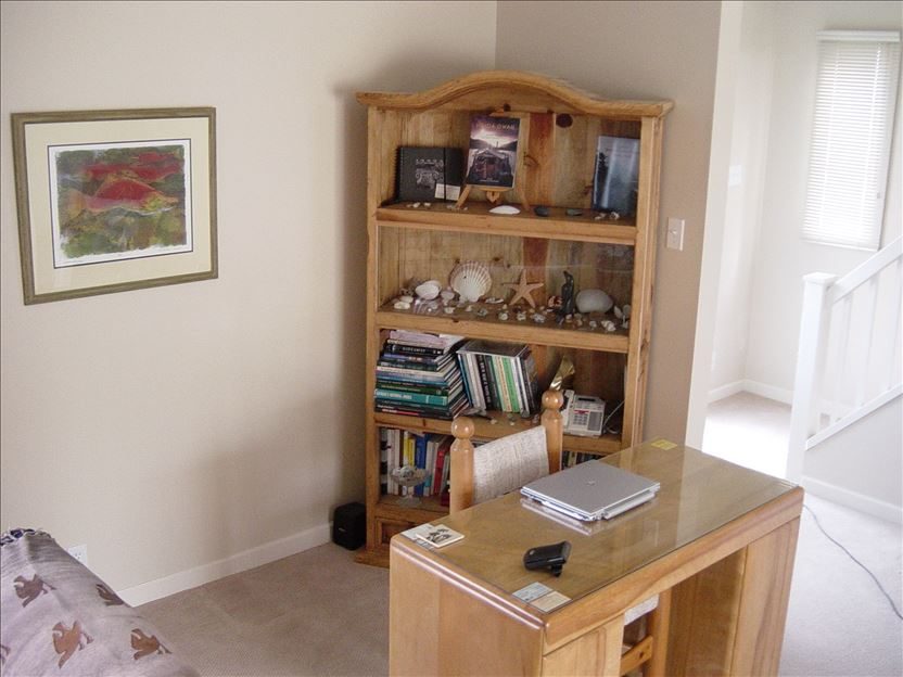 A quiet reading corner with a bookshelf and desk in the lodge