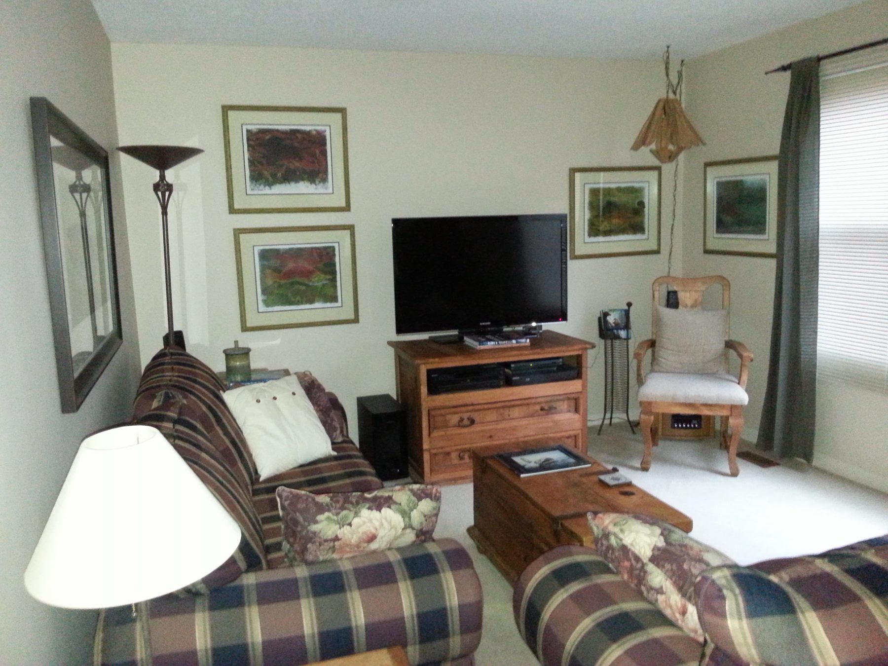 A comfortable lodge sitting room with sofas and warm timber furniture